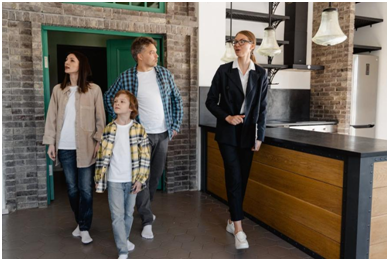 A real estate agent showing a house to a family 