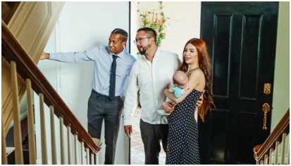 A real estate agent showing a house to a family 